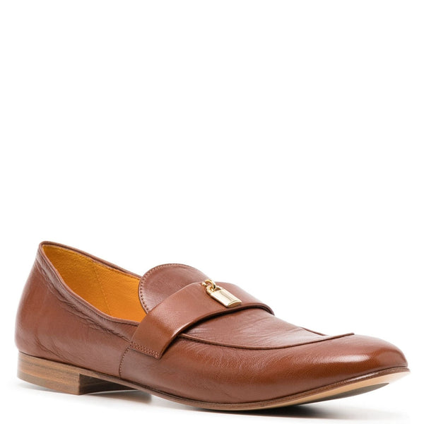 Tan leather flat loafer with round toe strap and gold lock hardware