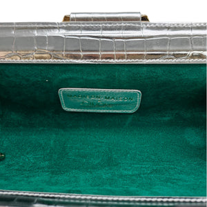 Green fabric-lined clutch interior with embossed logo label