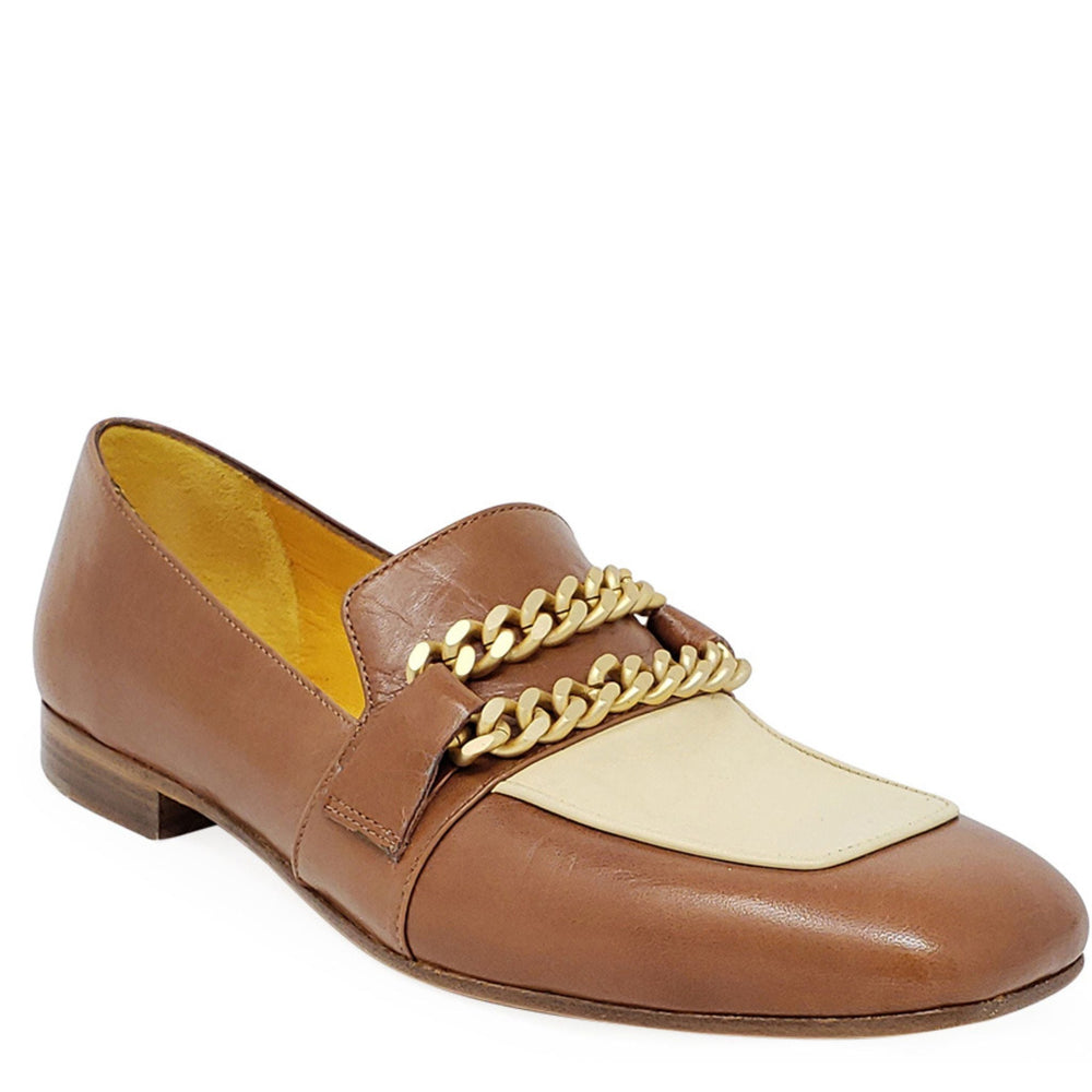 Tan flat loafer with cream panel, gold chain detail, and low wooden-look heel