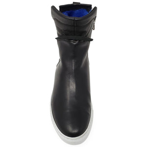 Black leather ankle boot heel view with blue shearling cuff and white outsole