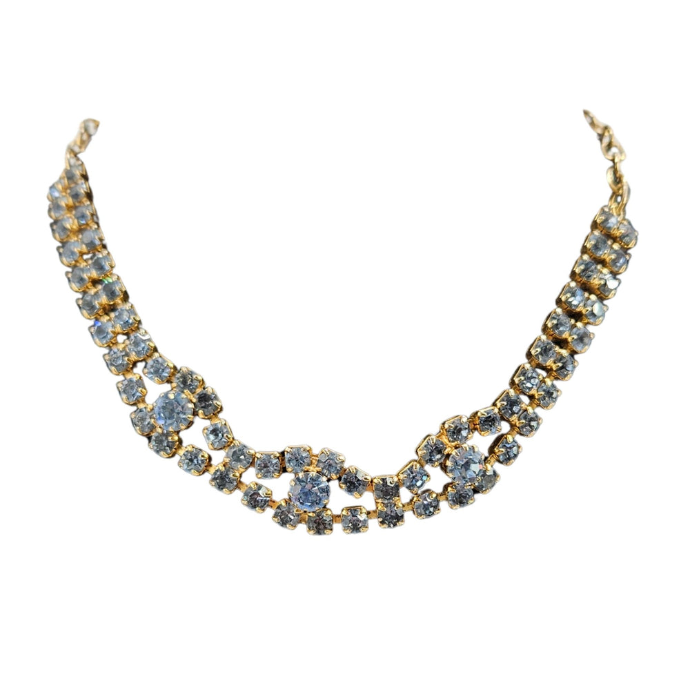 Blue faceted rhinestone necklace with linked rows and scalloped curve