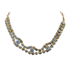 Blue faceted rhinestone necklace with linked rows and scalloped curve