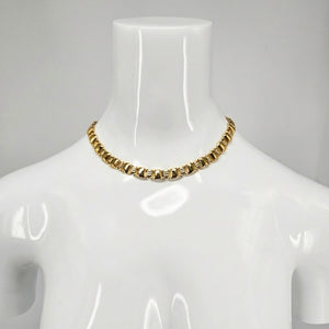 Gold-tone link collar necklace, choker length on a mannequin neck