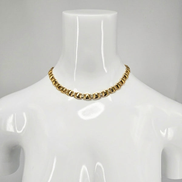 Gold-tone link collar necklace, choker length on a mannequin neck