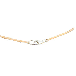 Beaded necklace strand with lobster clasp and small metal ring at center