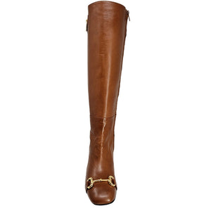 Cognac tall heeled lock boot with lock pull detail and buckle hardware near toe opening