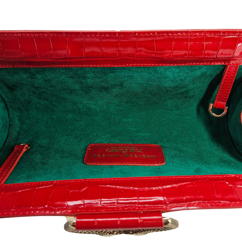 Red croc-embossed leather clutch with glossy finish and gold chain top handle