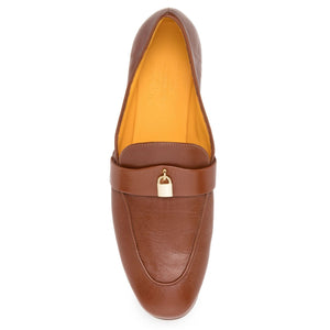 Tan leather slip-on flat loafer with gold lock detail on top strap