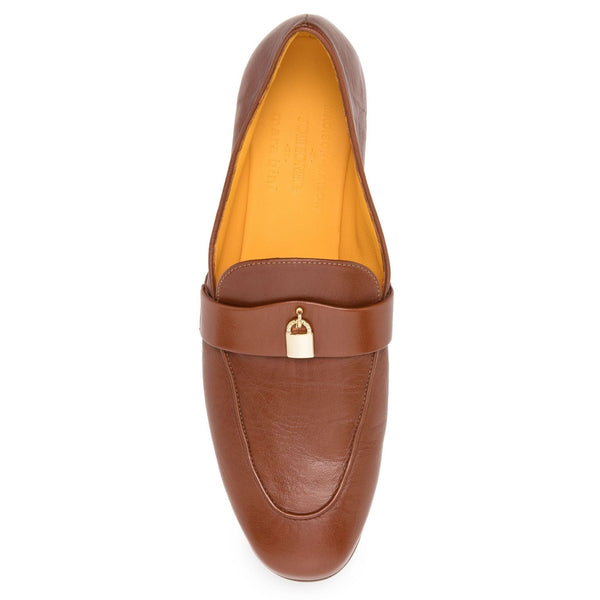 Tan leather slip-on flat loafer with gold lock detail on top strap