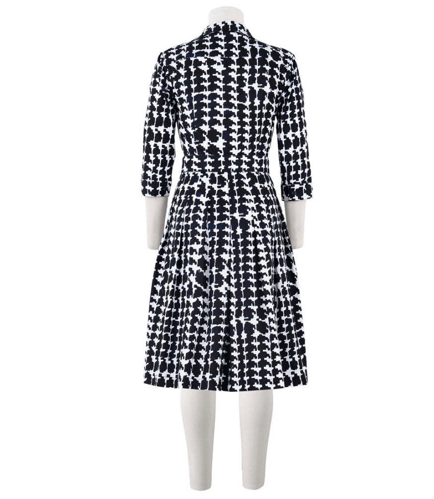 Black-and-white patterned long-sleeve dress with V neck collar and defined waist