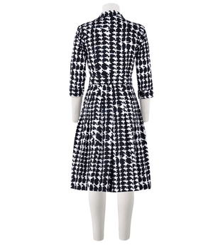 Black-and-white patterned long-sleeve dress with button front and fitted waist