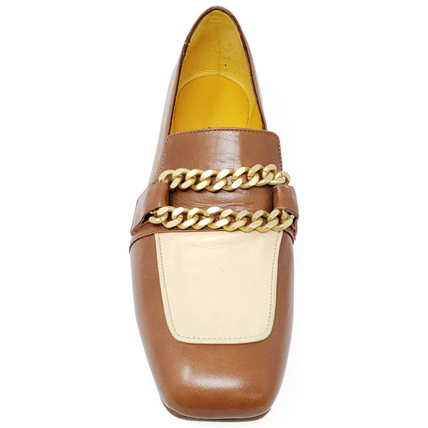 Front view of tan flat loafer with cream pocket and gold chain ornament