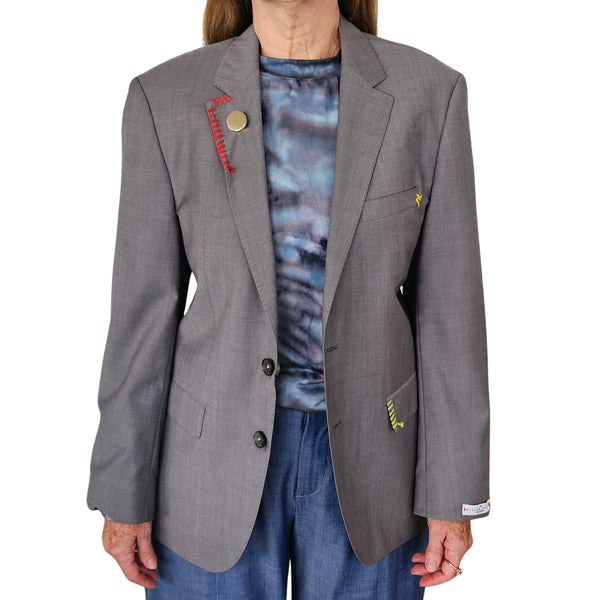 Grey blazer with notch lapels, two-button front, and flap pockets