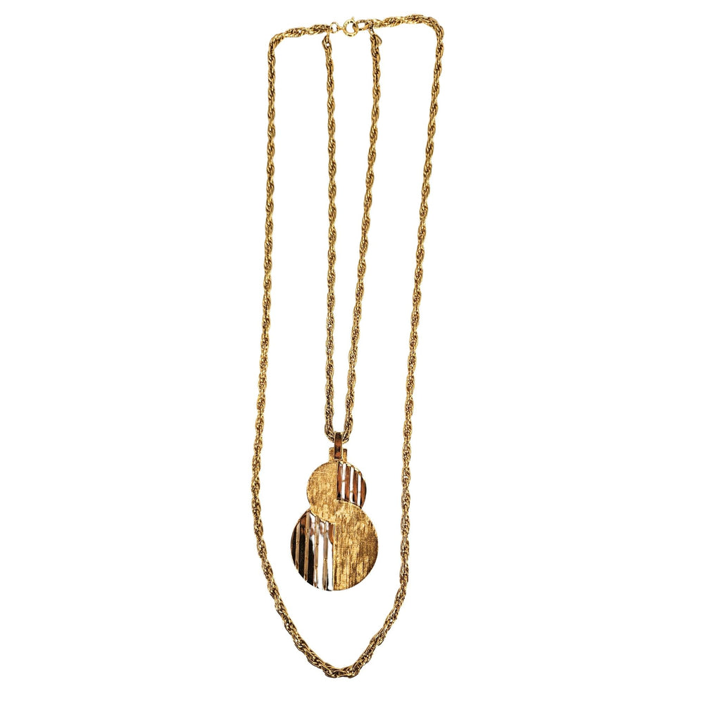 Gold-tone pendant necklace with stacked round cutout discs and linked chain