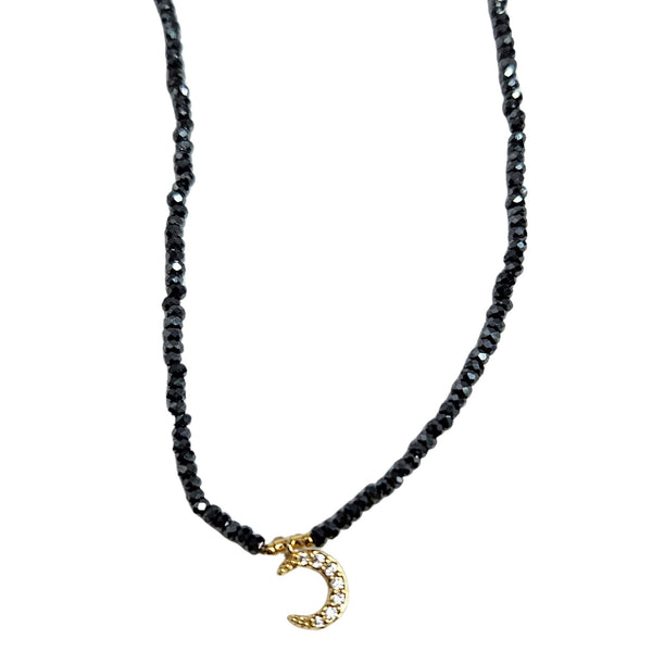 Gray beaded choker necklace with small gold crescent charm at center front