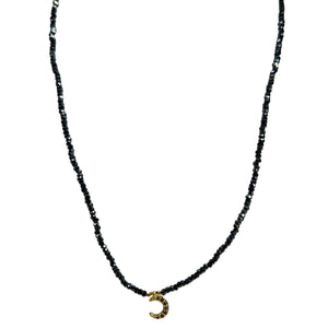 Gray beaded choker necklace in U shape with gold crescent pendant at neckline