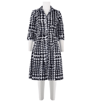 Black-and-white patterned long-sleeve dress with open collar and midi skirt