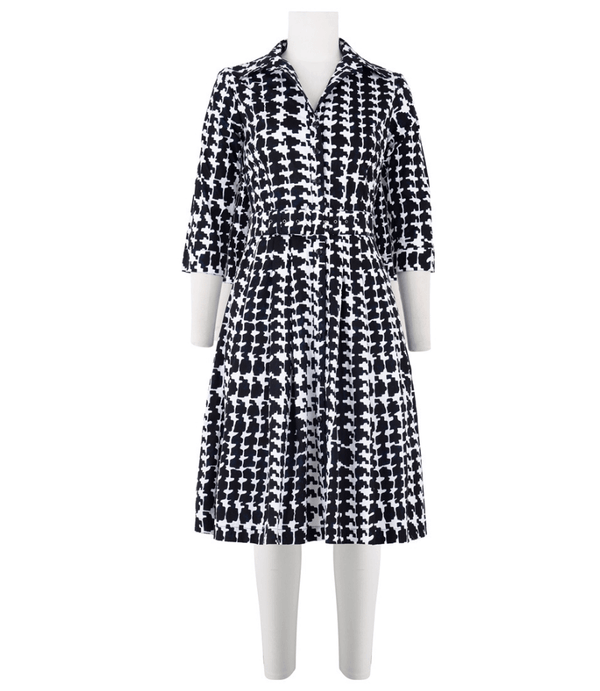 Black-and-white patterned long-sleeve dress with open collar and midi skirt
