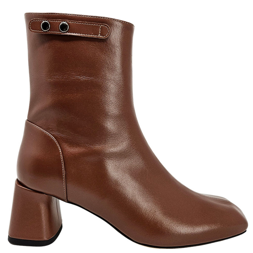 Brown leather ankle boot with chunky heel and strap with metal eyelets at top.