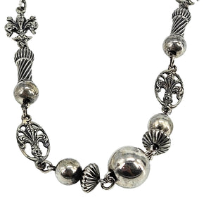 Sterling silver fleur-de-lis station necklace with mirrored round beads and ornate end charms