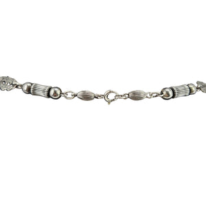 Sterling silver necklace chain with textured links, oval stations, and round bead accents
