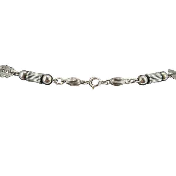 Sterling silver necklace chain with textured links, oval stations, and round bead accents