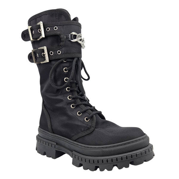 Black lace-up combat boot with buckled straps and silver chain detail