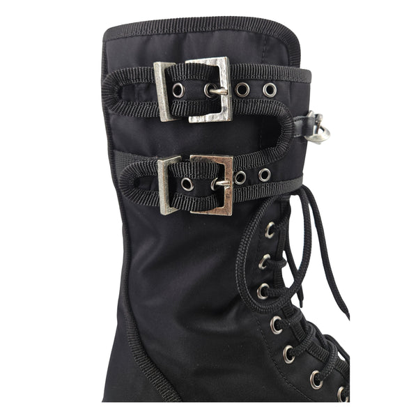 Black combat boot upper with buckled straps, metal eyelets, and lace-up front