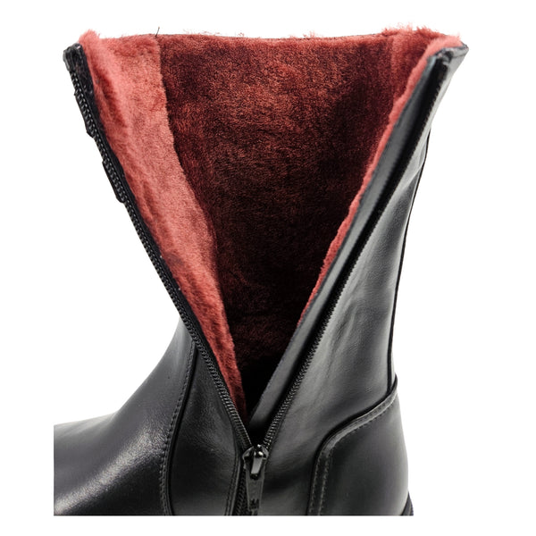 Black boot collar showing shearling lining and side zipper opening.