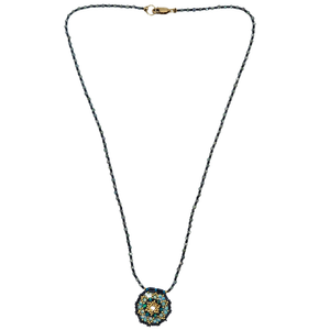 Beaded dreamer necklace with long dark blue bead chain and small round blue-teal pendant