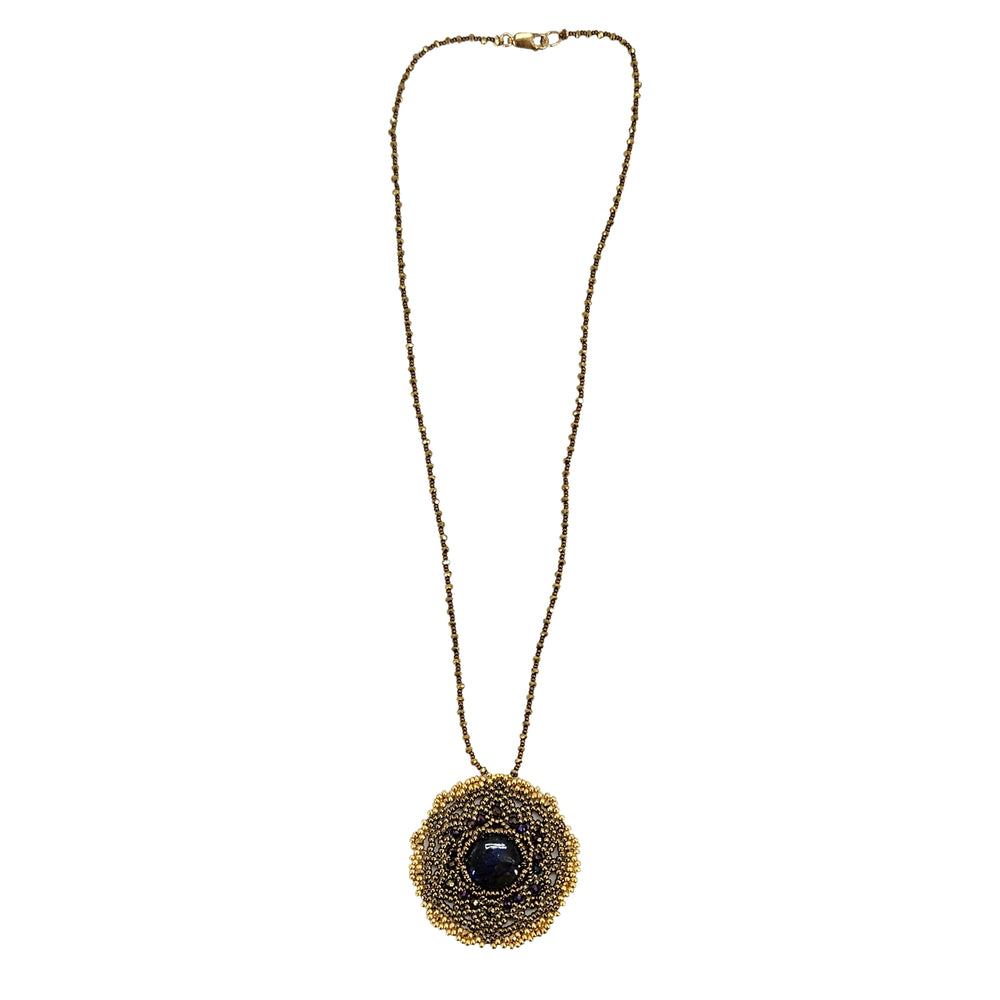Gold-tone necklace with circular mandala pendant and dark labradorite-style center