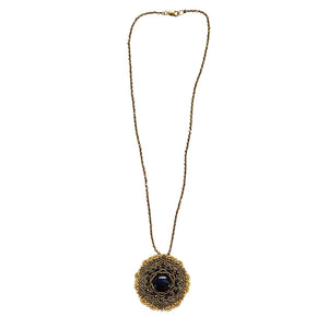 Gold-tone necklace with circular mandala pendant and dark labradorite-style center