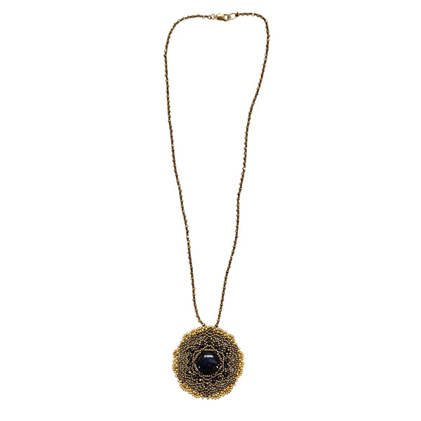 Gold-tone necklace with circular mandala pendant and dark labradorite-style center