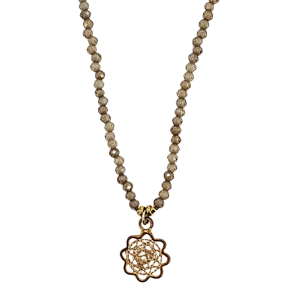 Brown beaded charm necklace with faceted strand, silver clasp, small flower charm