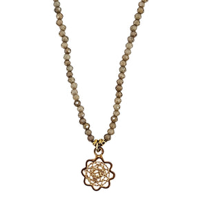Brown beaded charm necklace with gold flower pendant and faceted beads