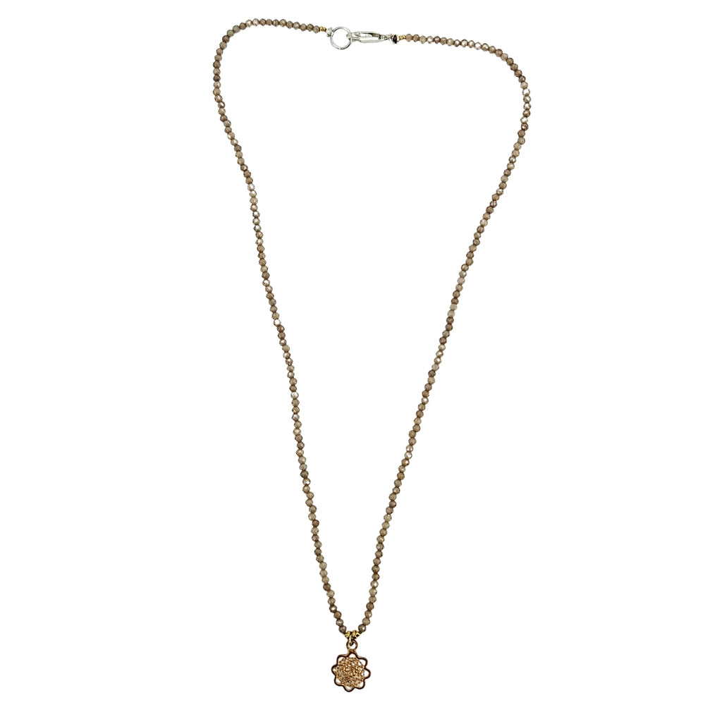 Brown beaded charm necklace with faceted strand, silver clasp, small flower charm