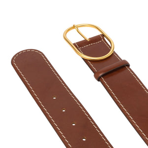 Brown leather belt strap with punched holes and gold buckle hardware
