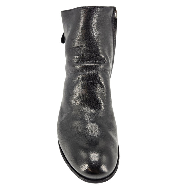 Black leather ankle boot back profile with low stacked block heel