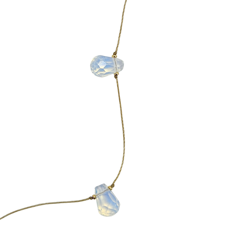 Teardrop gemstone station necklace with pale white teardrop charms on thin chain