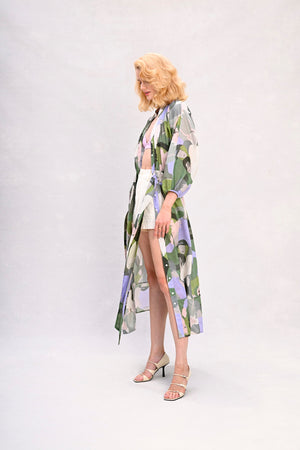 Long shirt dress with waist tie, green and lavender face print, side view