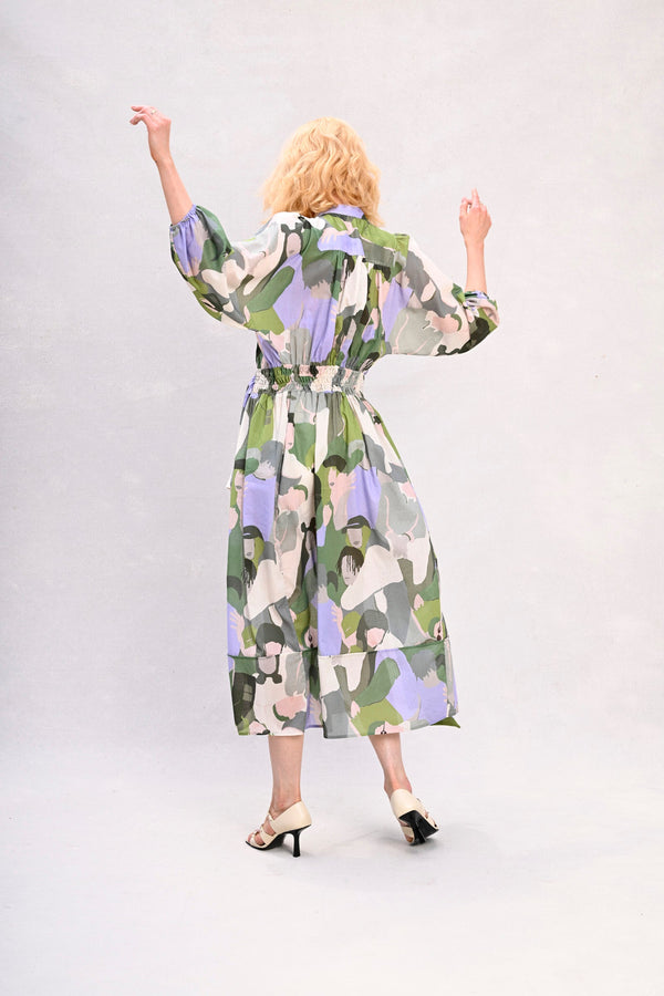 Long shirt dress with waist tie, green and lavender face print, back view