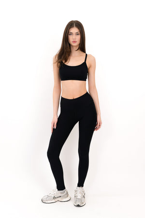 Black sports bra with thin straps and scoop neckline, front view