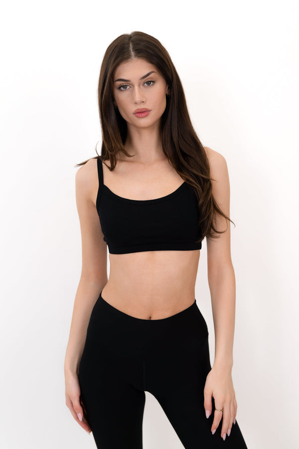 Black sports bra with thin straps and scoop neckline, front view