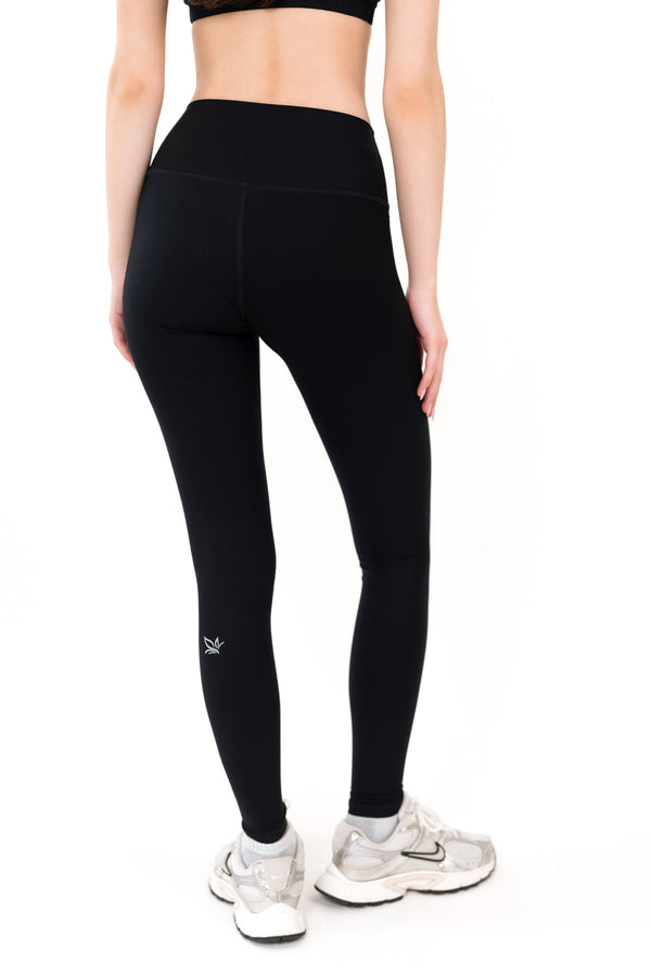 Black performance leggings with small left-thigh logo, full length.