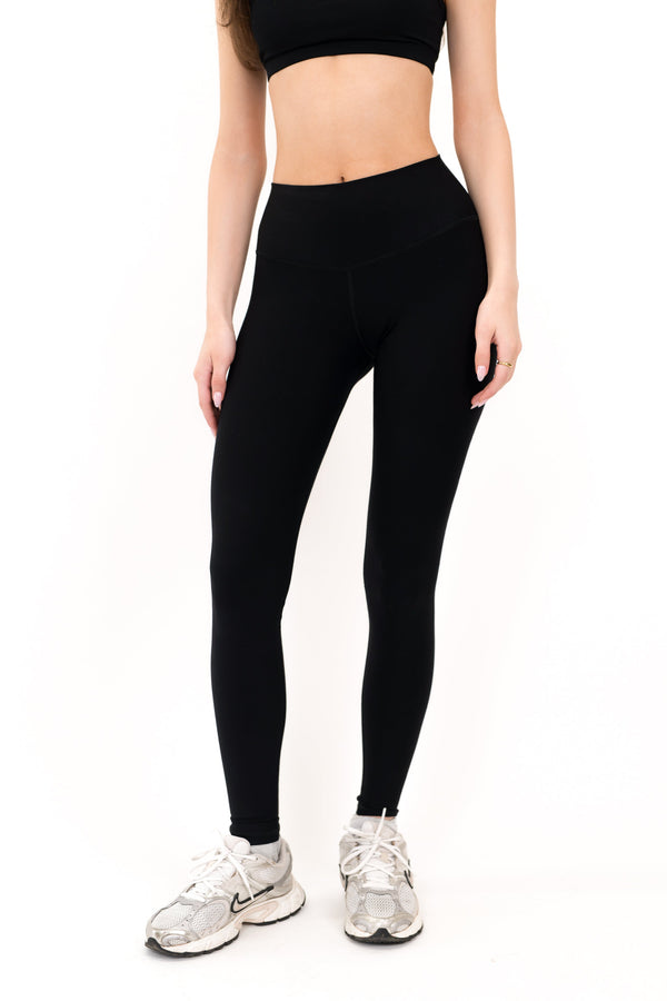 Black full-length leggings with high-waist band and smooth seam line.
