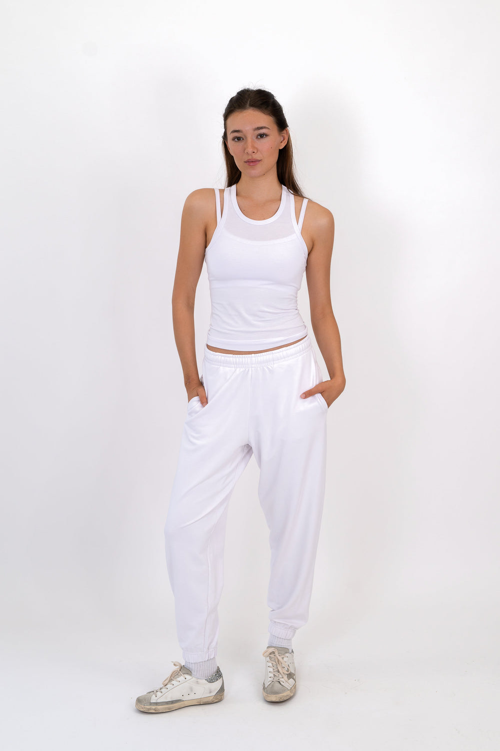 White sweatpants with elastic waistband and tapered cuffs
