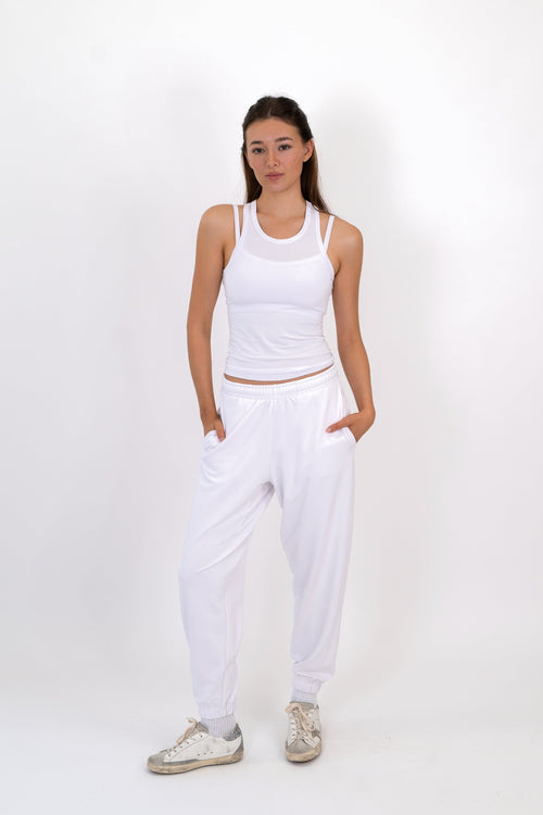 White sweatpants with elastic waistband and tapered cuffs