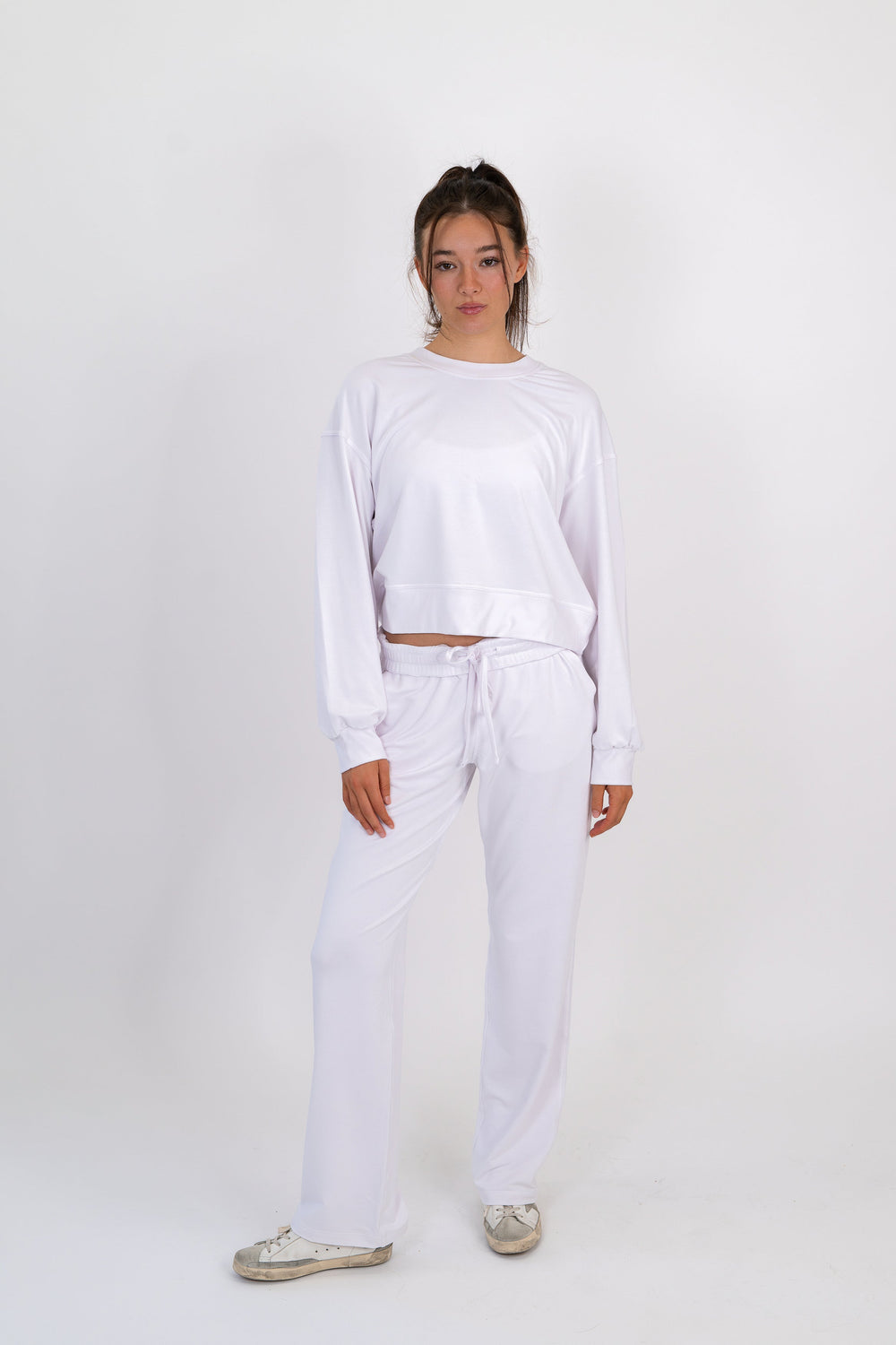 White wide-leg sweatpants with drawstring waist and relaxed straight legs