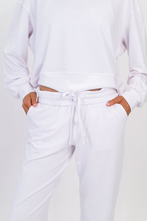 White sweatpants with tied drawstring and elastic waistband