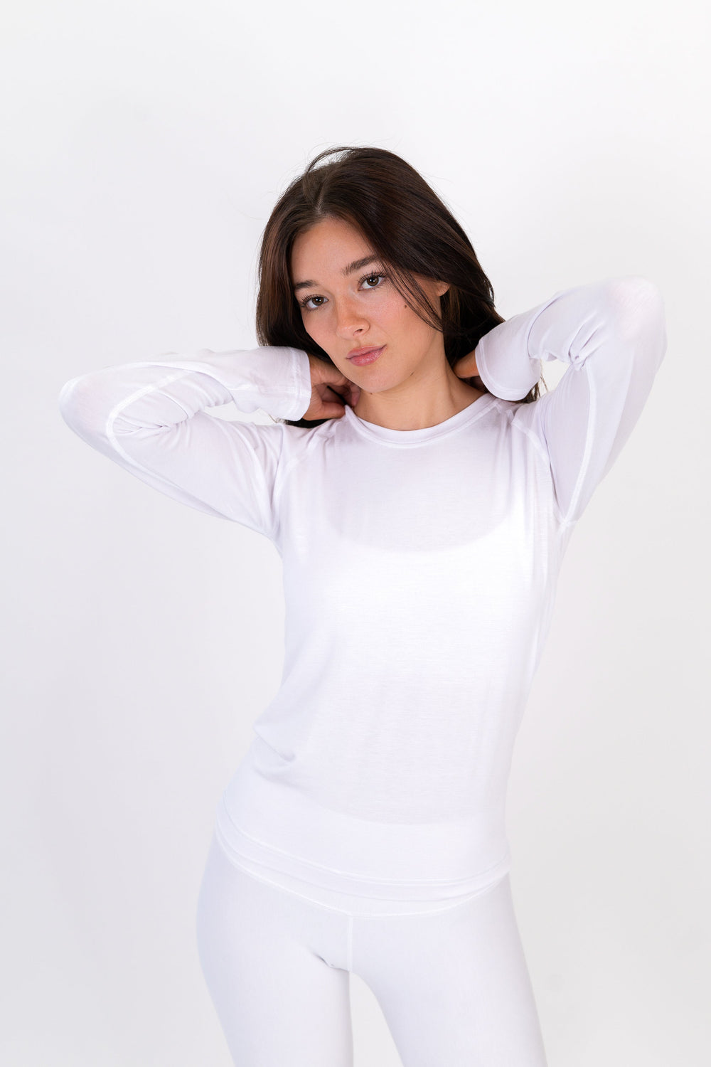 White long-sleeve fitted crewneck shirt with subtle stitching.